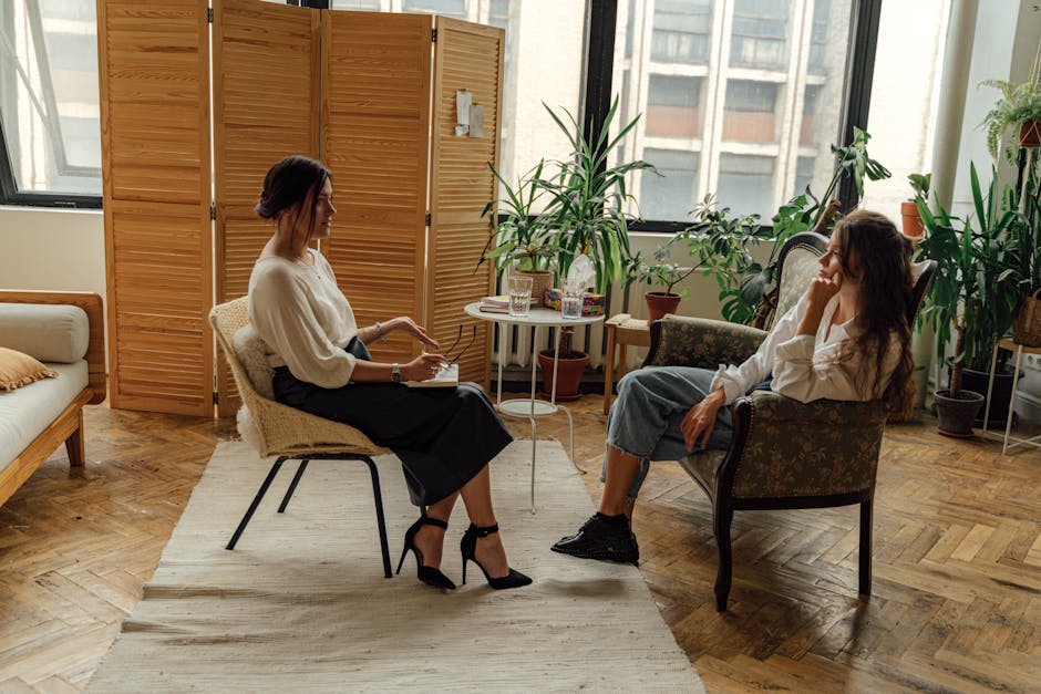 Two women sit in a therapy session, creating a tranquil and professional environment